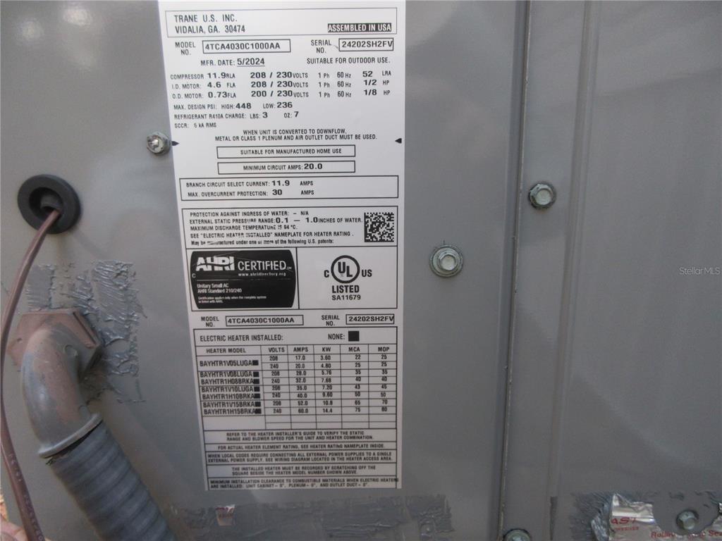 This is a close-up view of a Trane HVAC unit data plate mounted outdoors — 2960 NE 159TH PLACE, CITRA, FL