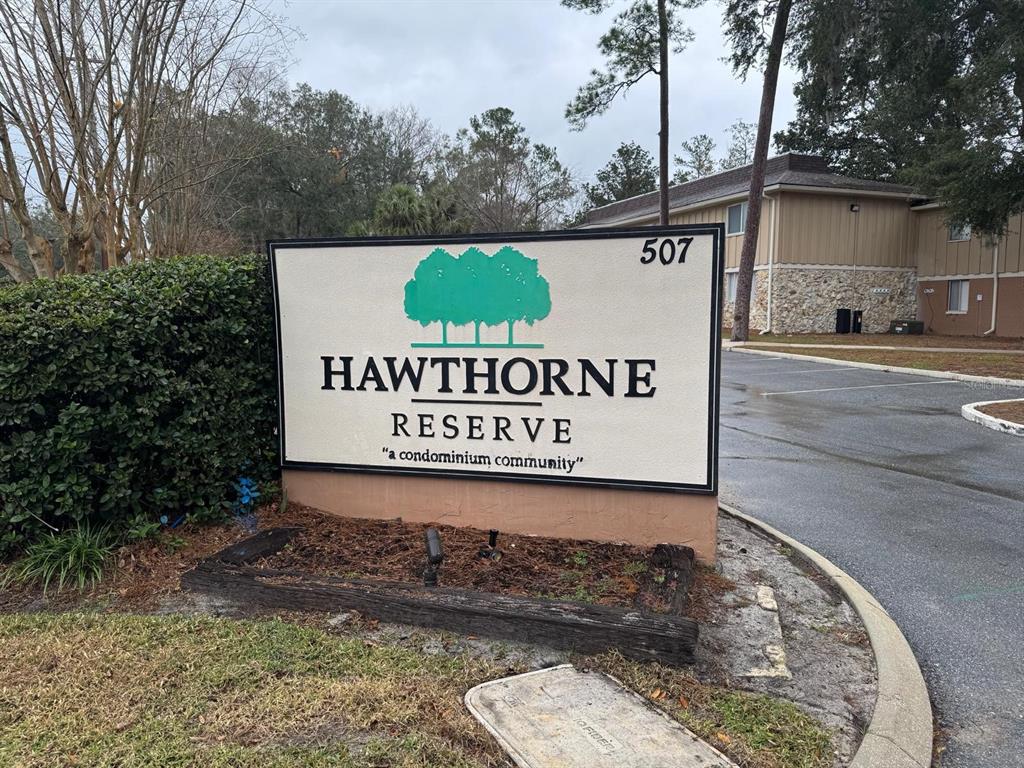 A sign for Hawthorne Reserve condominium community stands near a parking lot and building — 507 NW 39TH ROAD UNIT 220, GAINESVILLE, FL
