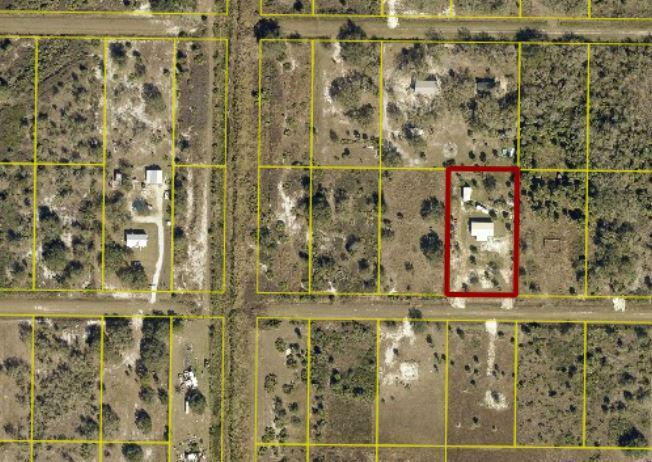 This is an aerial map view showing a rectangular property lot outlined in red — 19835 NW 266 Street, Okeechobee FL 34972, OKEECHOBEE, FL