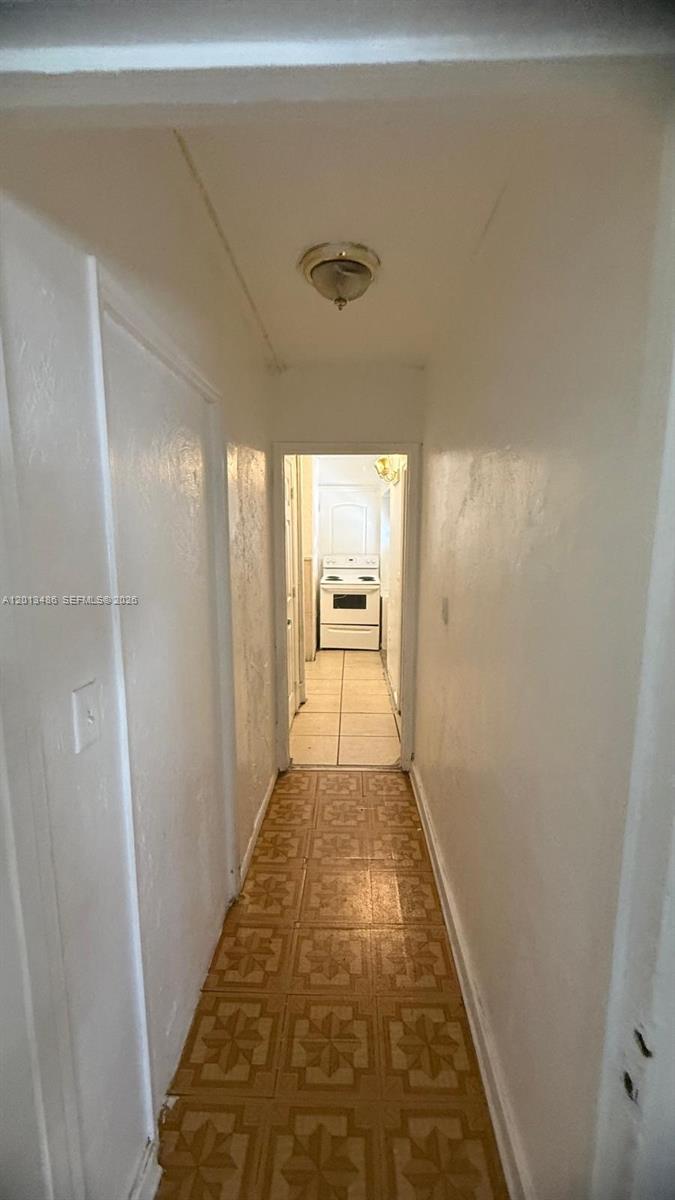 A small bathroom features a pedestal sink, a toilet, and an exposed white plumbing pipe — 725 Opa Locka Blvd # C, Opa-Locka FL 33054, OPA-LOCKA, FL