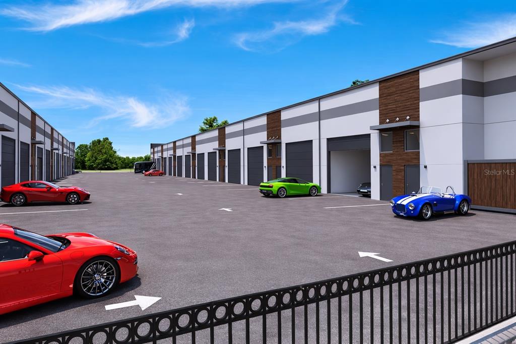 This is a rendering of a commercial storage facility exterior with parked luxury cars — 5864 DEREK AVENUE UNIT 3, SARASOTA, FL