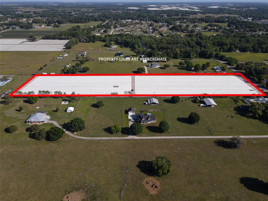 An aerial view shows a large, rectangular plot of land covered by white plastic sheeting — 3811 OLD MULBERRY ROAD, PLANT CITY, FL