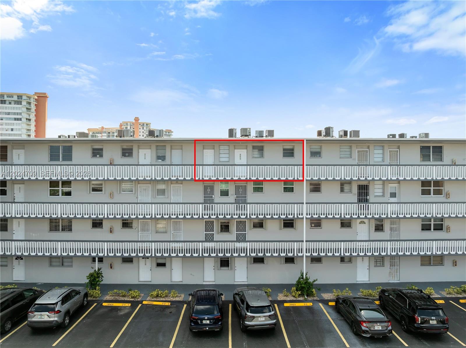 Exterior view of a multi-story apartment building with a red box highlighting a unit — 18601 NE 14th Ave # 409, Miami FL 33179, MIAMI, FL