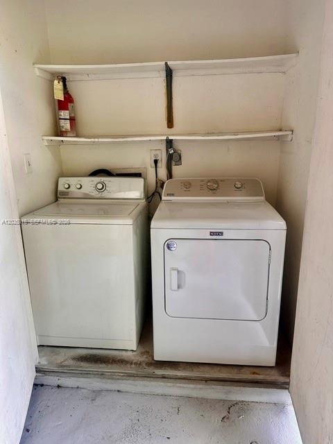 A laundry closet contains a white top-loading washing machine and a white front-loading dryer — 10670 SW 156th Pl # 301, Miami FL 33196, MIAMI, FL