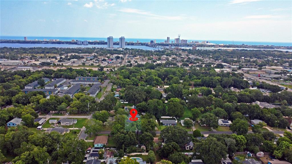 An aerial view shows a residential neighborhood with a red location pin on a house — 126 PALM DRIVE, DAYTONA BEACH, FL