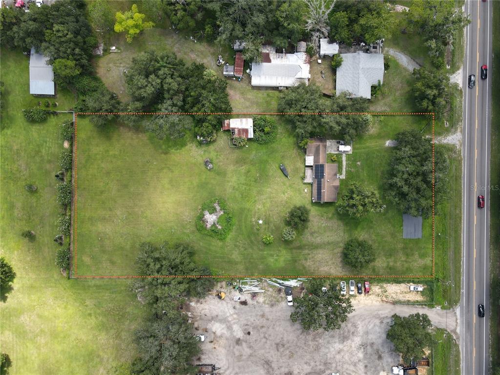 An aerial view shows a rectangular residential lot with a house, shed, and trees — 6043 S ORANGE BLOSSOM TRAIL, DAVENPORT, FL