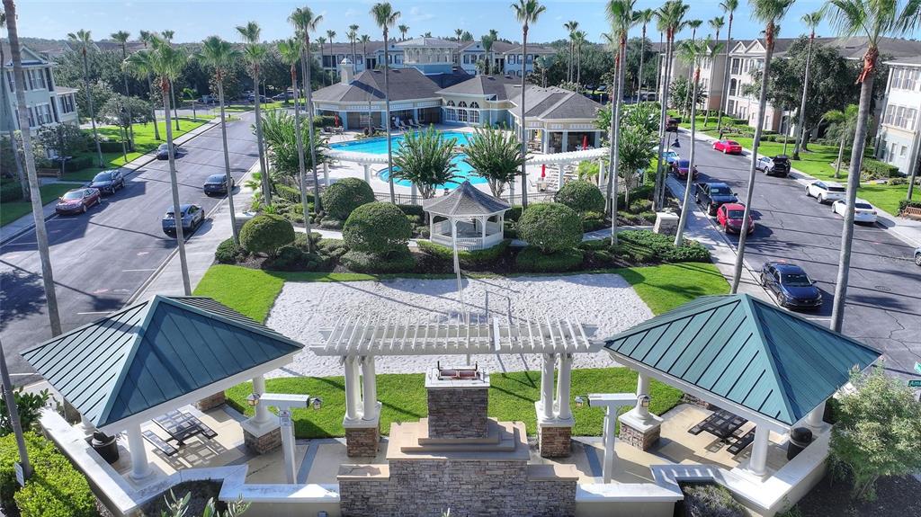 An aerial view shows a community pool, gazebo, sand volleyball court, and surrounding apartment buildings — 11564 MIZZON DRIVE UNIT 923, WINDERMERE, FL