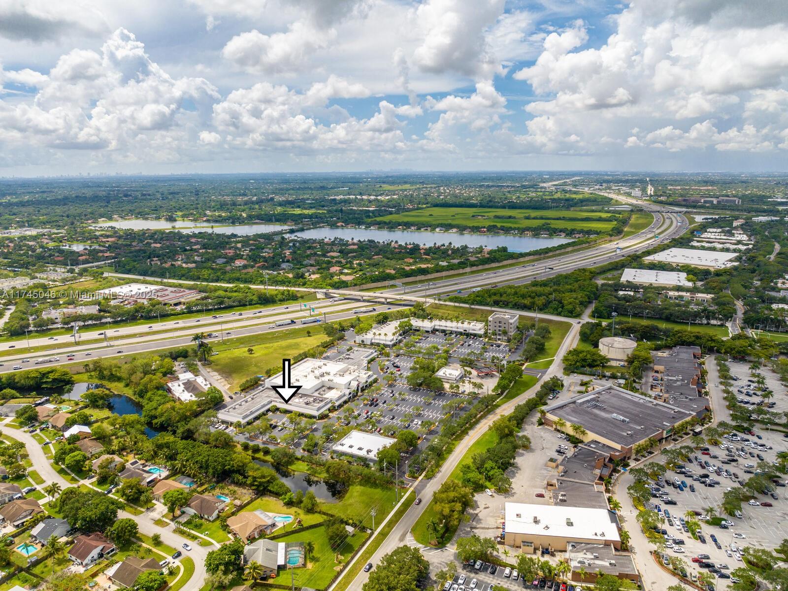 An aerial view shows a commercial building complex with parking lots near a highway — 1320 SW 160th Ave, Weston FL 33326, WESTON, FL