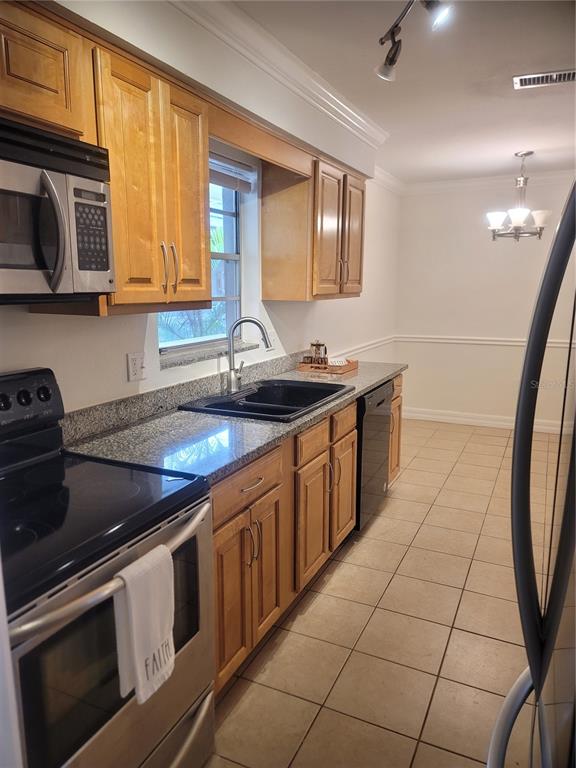 A kitchen with light wood cabinets, granite countertops, a black sink, and stainless steel appliances — 3360 S OSPREY AVENUE UNIT 201B, SARASOTA, FL