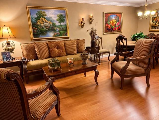 A living room features a sofa, two armchairs, a coffee table, and framed wall art — 16236 SW 100th Ter, Miami FL 33196, MIAMI, FL