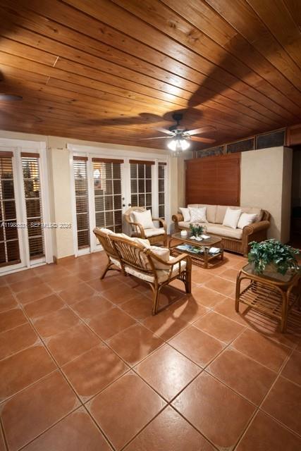 A sunroom features a wood-paneled ceiling, tile flooring, wicker furniture, and glass-paned doors — 16236 SW 100th Ter, Miami FL 33196, MIAMI, FL