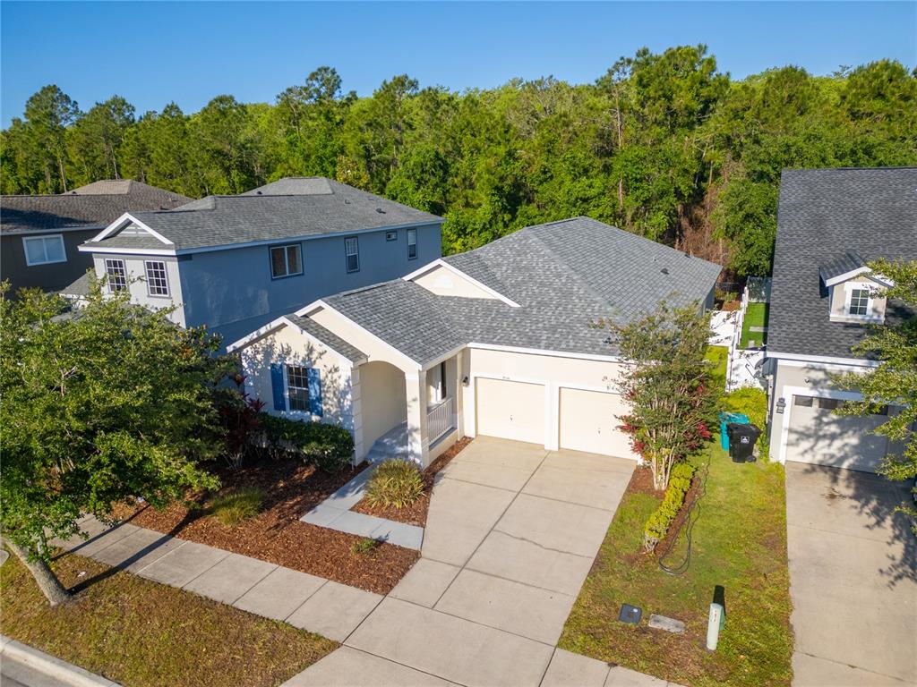 An aerial view shows a single-story house with a two-car garage and gray roof — 9516 PICCADILLY SKY WAY, ORLANDO, FL