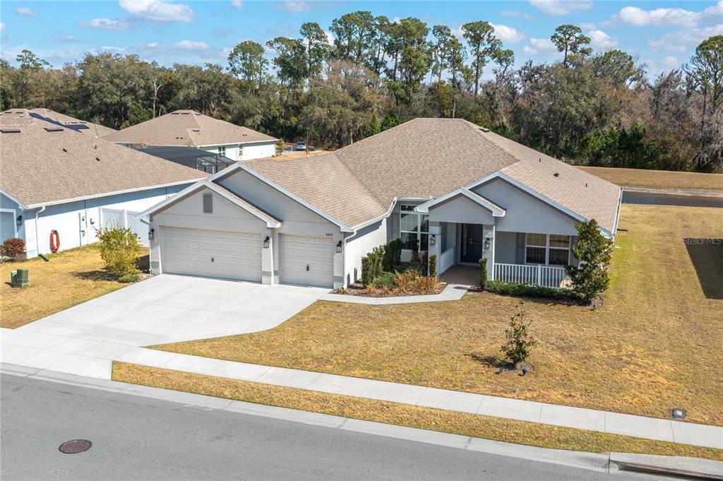 An aerial view of a single-story suburban house with a three-car garage and lawn — 5455 KNIGHTS LANDING DRIVE, LAKELAND, FL