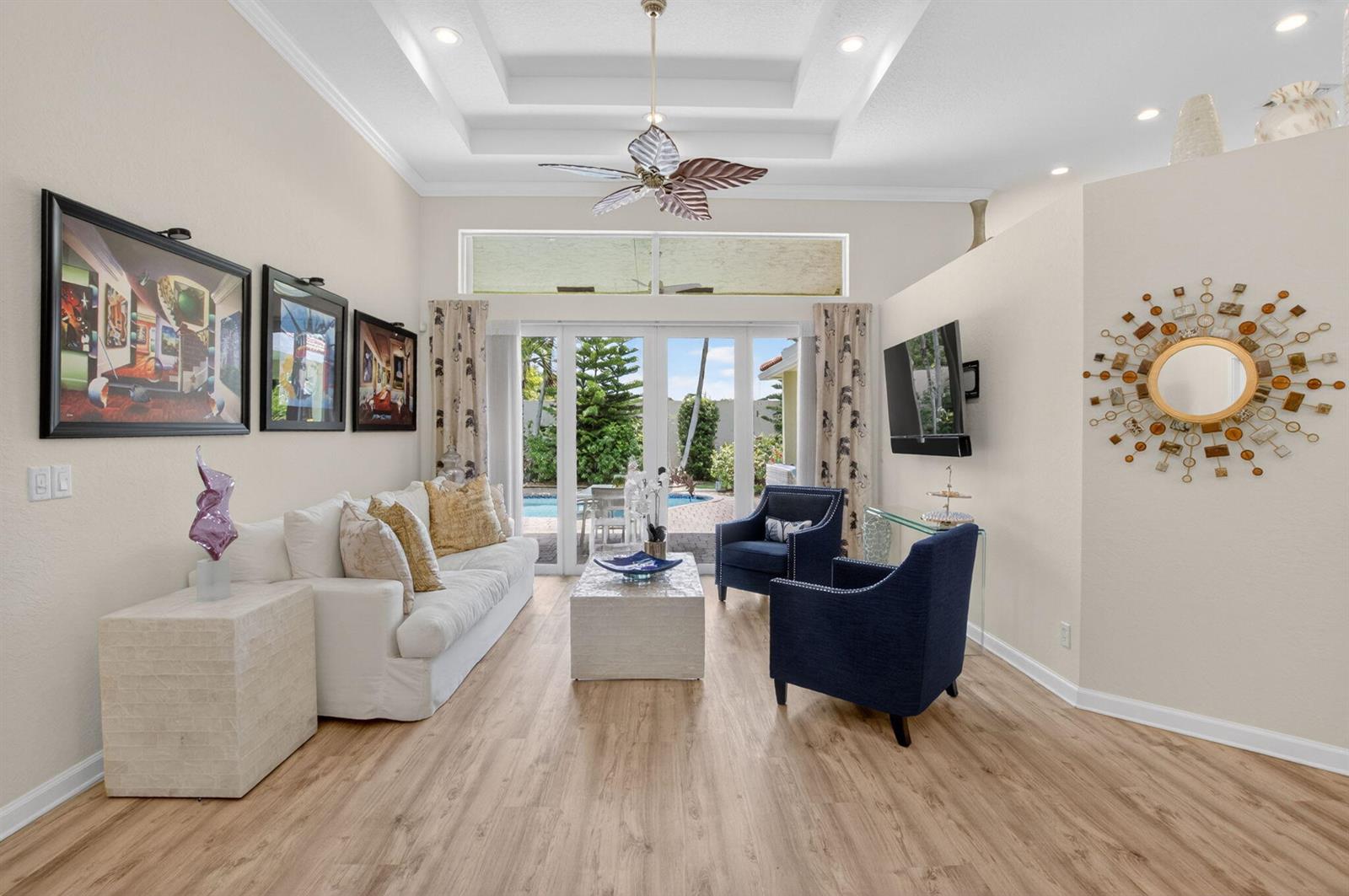 A living room features a white sofa, two blue armchairs, a coffee table, and patio doors — 12657 Oak Run Court, Boynton Beach FL 33436, BOYNTON BEACH, FL