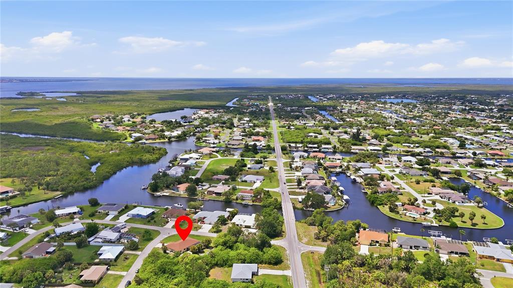 An aerial view shows a residential neighborhood with canals and a house marked by a pin — 19358 ABHENRY CIRCLE, PORT CHARLOTTE, FL