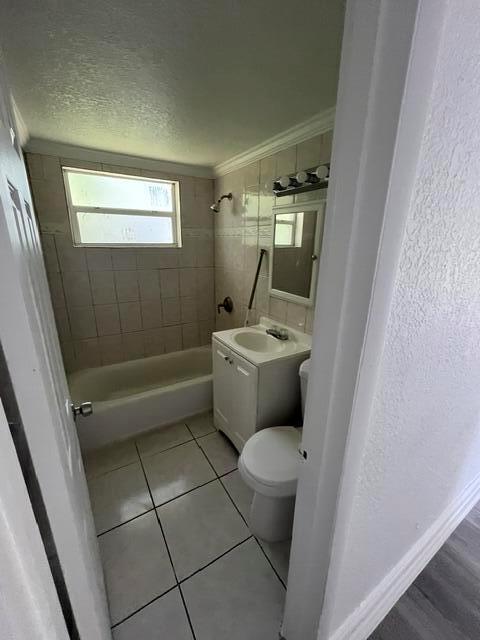 A bathroom features a tiled shower-tub combination, a pedestal sink, and a white toilet — 3150 NW 3rd Street, Lauderhill FL 33311, LAUDERHILL, FL
