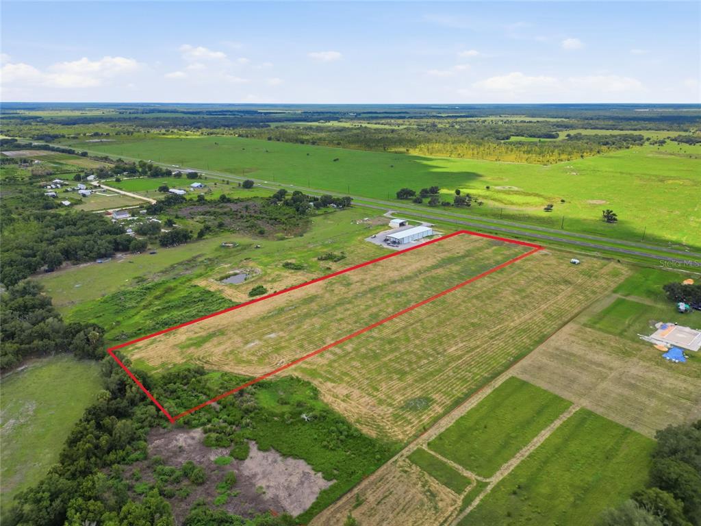 An aerial view shows a rectangular plot of land outlined in red near a road — S US HWY 17, ZOLFO SPRINGS, FL