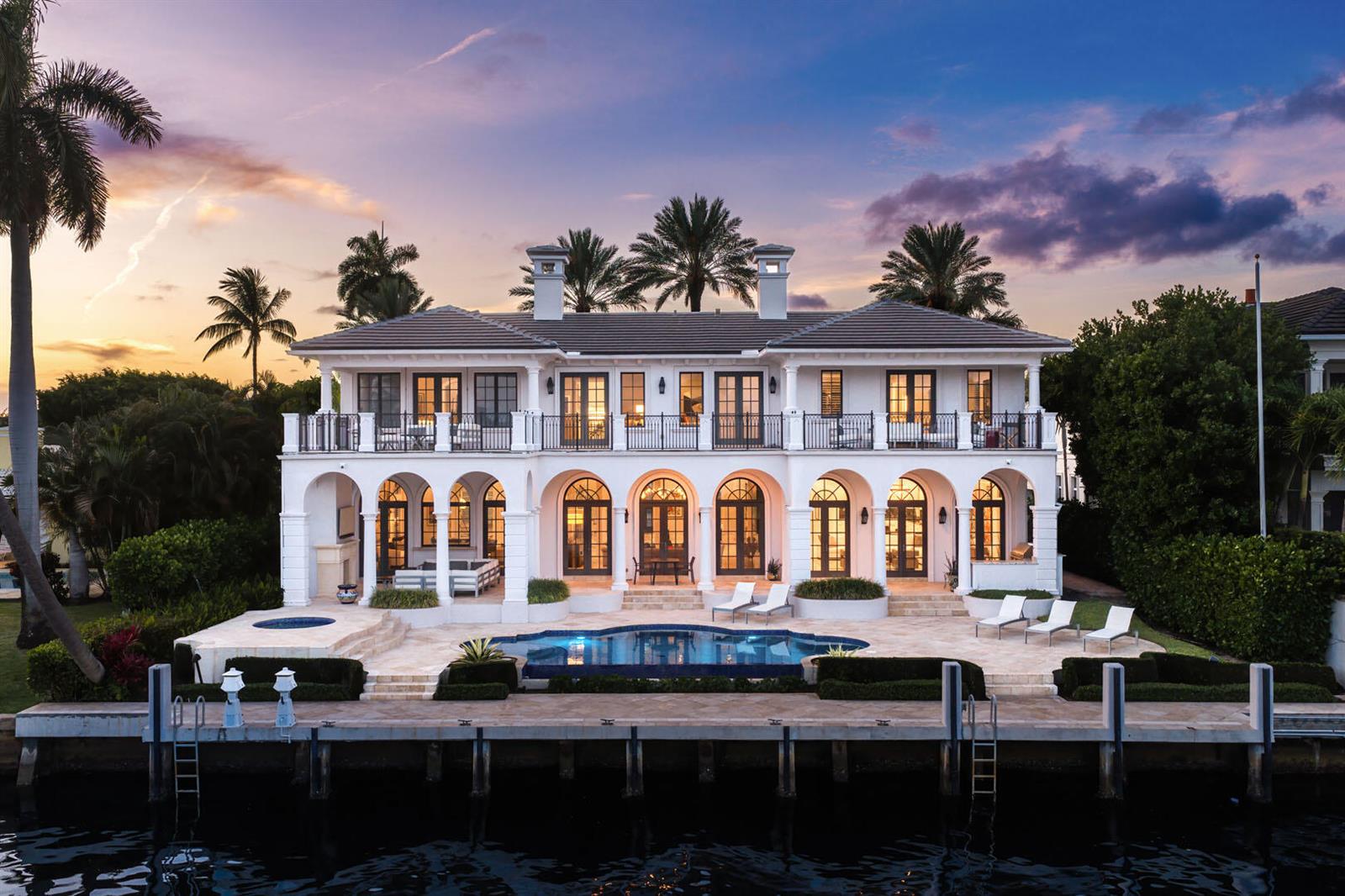 A two-story white waterfront villa features arched doorways, a swimming pool, and a private dock — 450 S Maya Palm Drive, Boca Raton FL 33432, BOCA RATON, FL