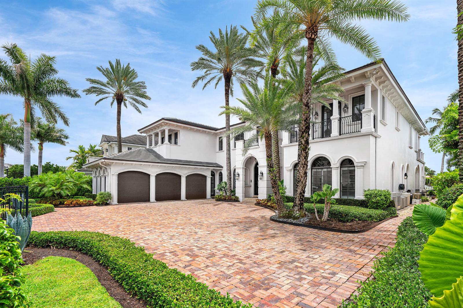 A large white two-story house with a brick driveway and palm trees in the front — 450 S Maya Palm Drive, Boca Raton FL 33432, BOCA RATON, FL