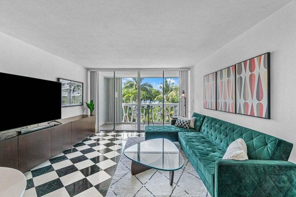 A living room features a green velvet sectional, checkered flooring, and a balcony with palm trees — 2505 S Ocean Boulevard # 303, Palm Beach FL 33480, PALM BEACH, FL