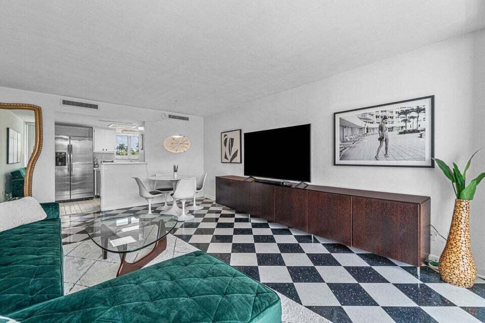 A living room features a green velvet sofa, checkered flooring, and a large media console — 2505 S Ocean Boulevard # 303, Palm Beach FL 33480, PALM BEACH, FL