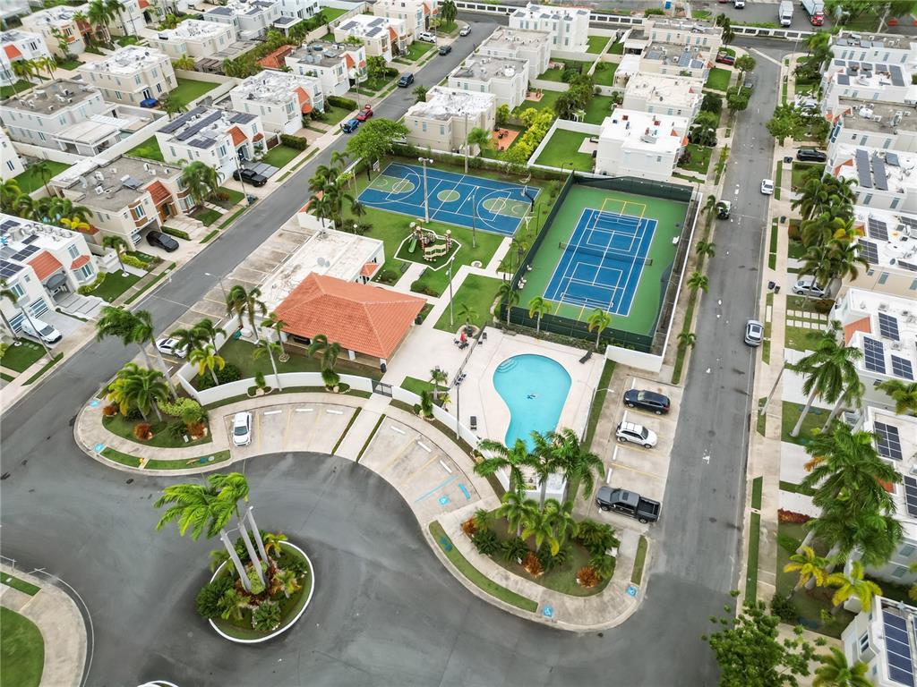 An aerial view shows a residential community with a pool, tennis court, and basketball court — L2 MAR MEDITERRANEO STREET, DORADO, PR