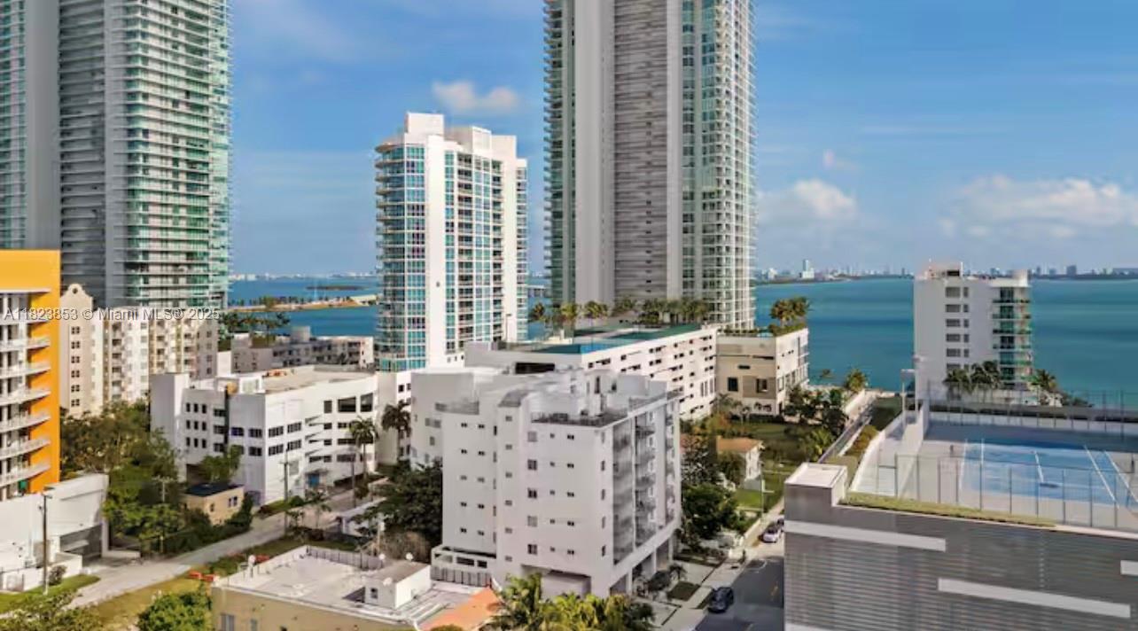 An aerial view of high-rise apartment buildings and a tennis court overlooking the ocean — 481 NE 29th St # 706, Miami FL 33137, MIAMI, FL