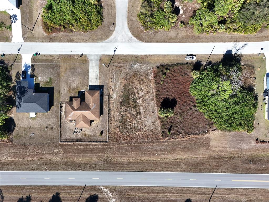 An aerial view shows a house next to two vacant lots along a paved road — 3019 S BALSAM CIRCLE, LABELLE, FL