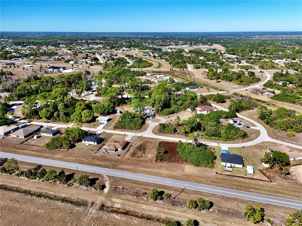 An aerial view shows a residential neighborhood with houses, trees, and a paved road — 3019 S BALSAM CIRCLE, LABELLE, FL