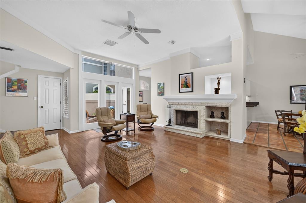 A living room with hardwood floors, a fireplace, and a ceiling fan — 786 MCINTYRE AVENUE, WINTER PARK, FL