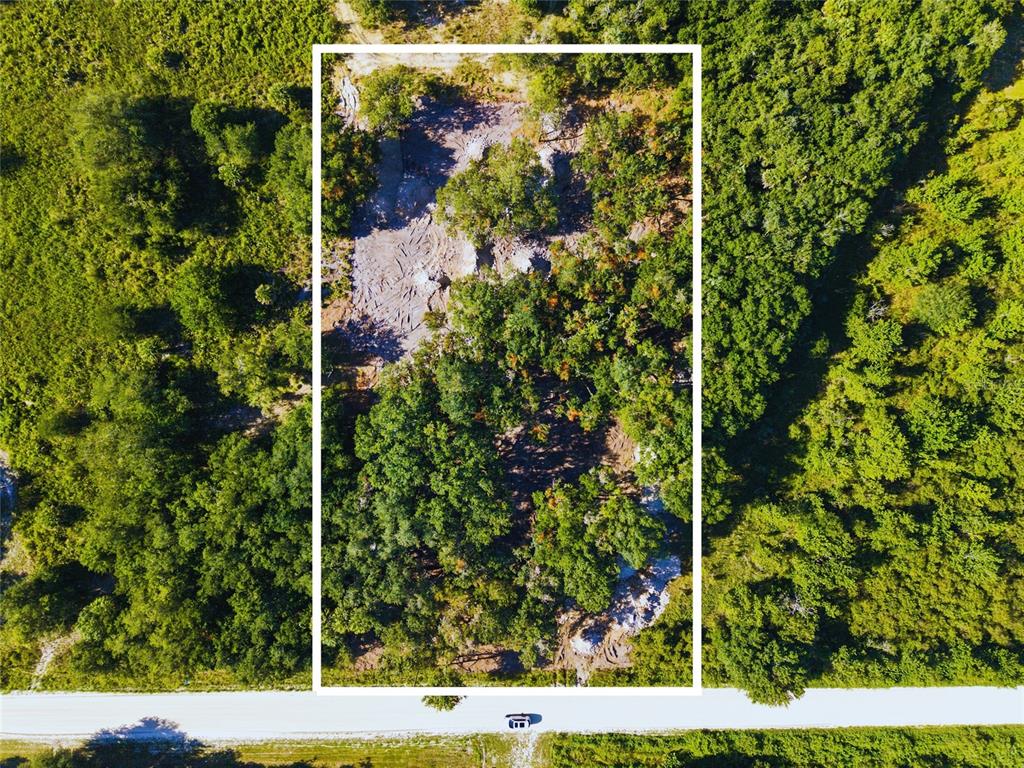 An aerial view shows a rectangular plot of land with cleared areas and dense trees — 20212 NW 288TH STREET, OKEECHOBEE, FL