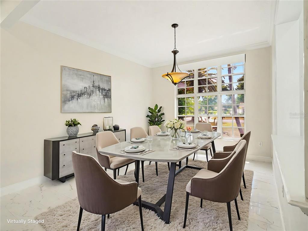 A dining room features a rectangular table, six chairs, a sideboard, and large grid windows — 7505 WEEPING WILLOW BOULEVARD, SARASOTA, FL