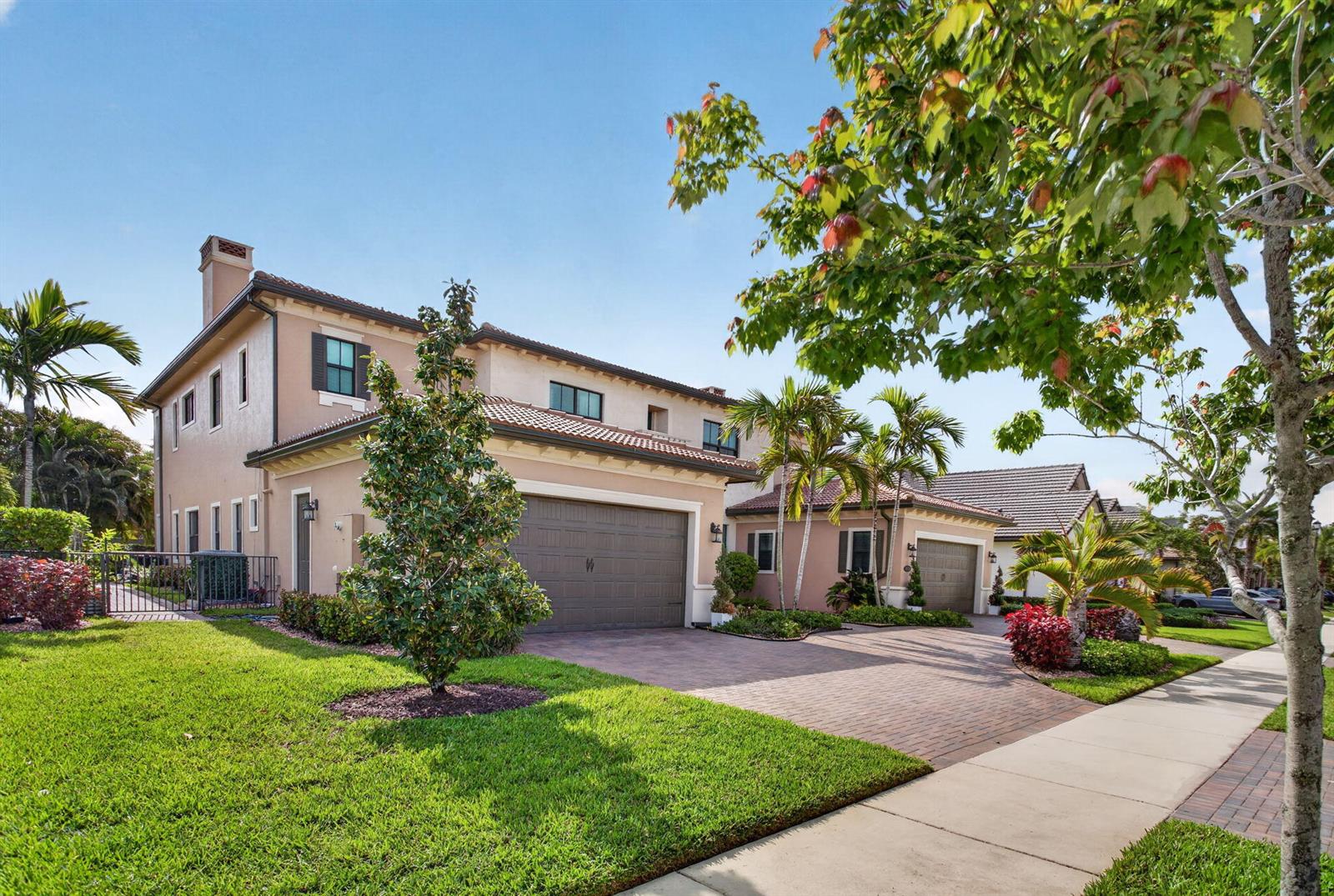 A two-story tan stucco house with a brown garage and a paved driveway — 9080 Vista Way, Parkland FL 33076, PARKLAND, FL