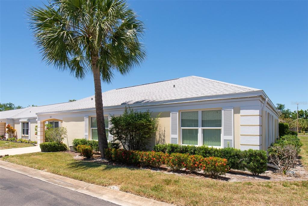 A single-story house with a palm tree, light-colored stucco walls, and a shingled roof — 8241 BRENTWOOD ROAD UNIT 8241, SEMINOLE, FL