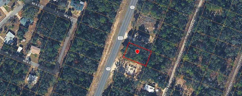 This aerial map shows a vacant, wooded rectangular lot outlined in red near a highway — TBD NE STATE ROAD 121, WILLISTON, FL