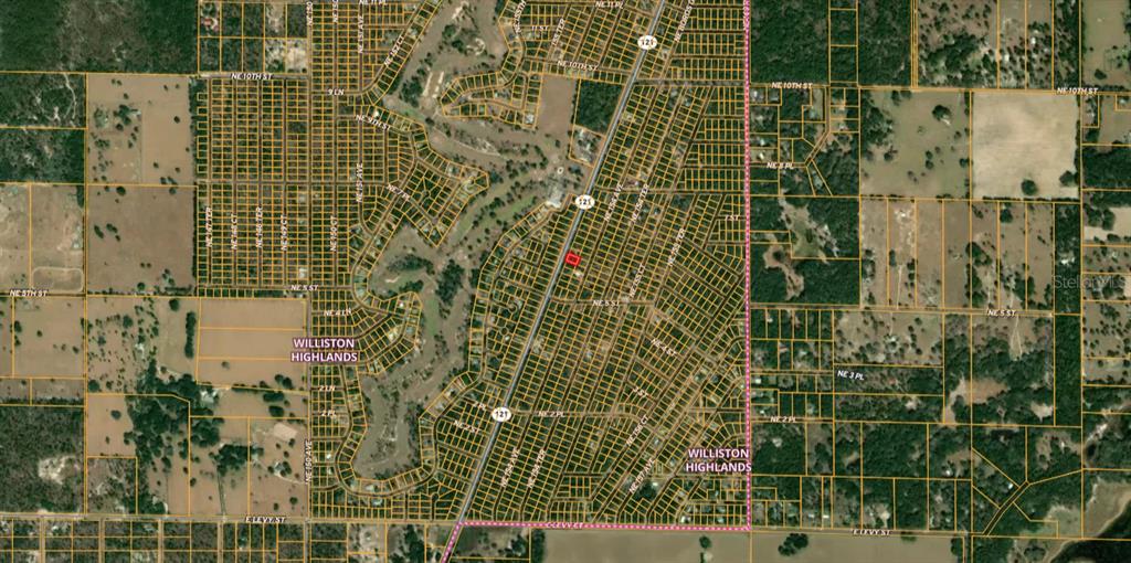 This is an aerial map showing a highlighted property lot within the Williston Highlands neighborhood — TBD NE STATE ROAD 121, WILLISTON, FL