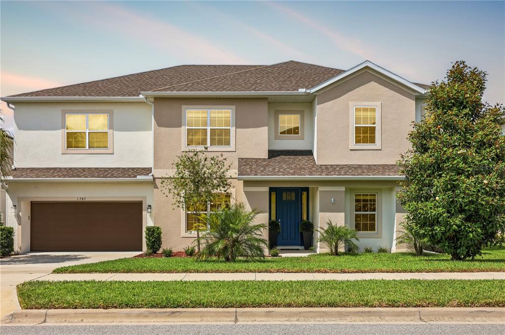 A two-story suburban house with a tan stucco exterior, brown roof, and attached garage — 1383 WATERVIEW RIDGE CIRCLE, APOPKA, FL