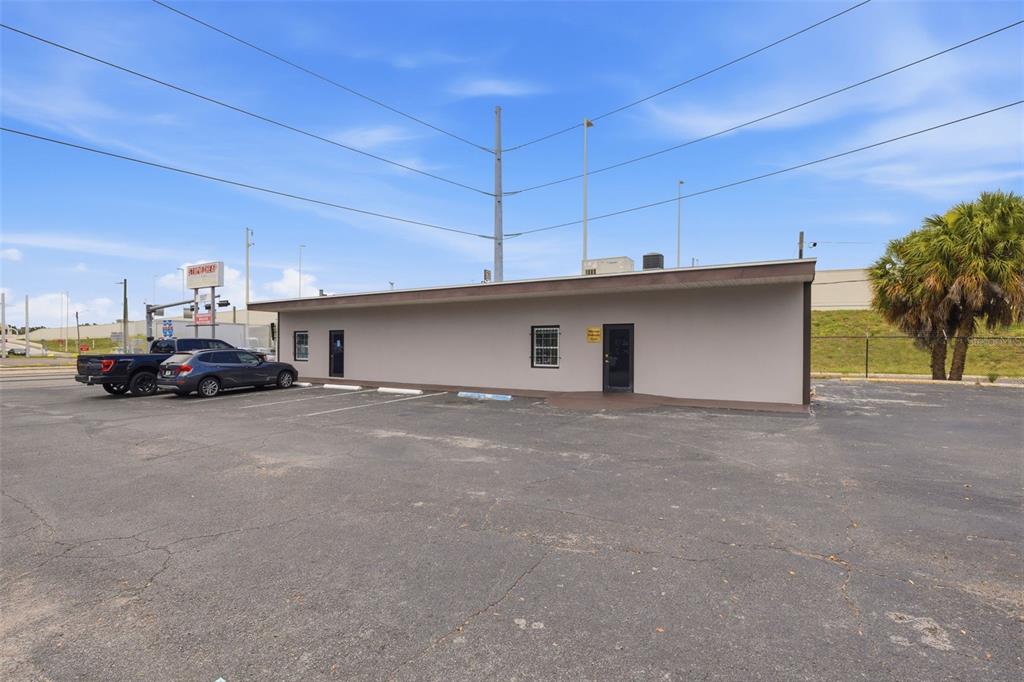 A single-story commercial building with a tan exterior and a parking lot — 507 E DR MARTIN LUTHER KING JR BOULEVARD, TAMPA, FL