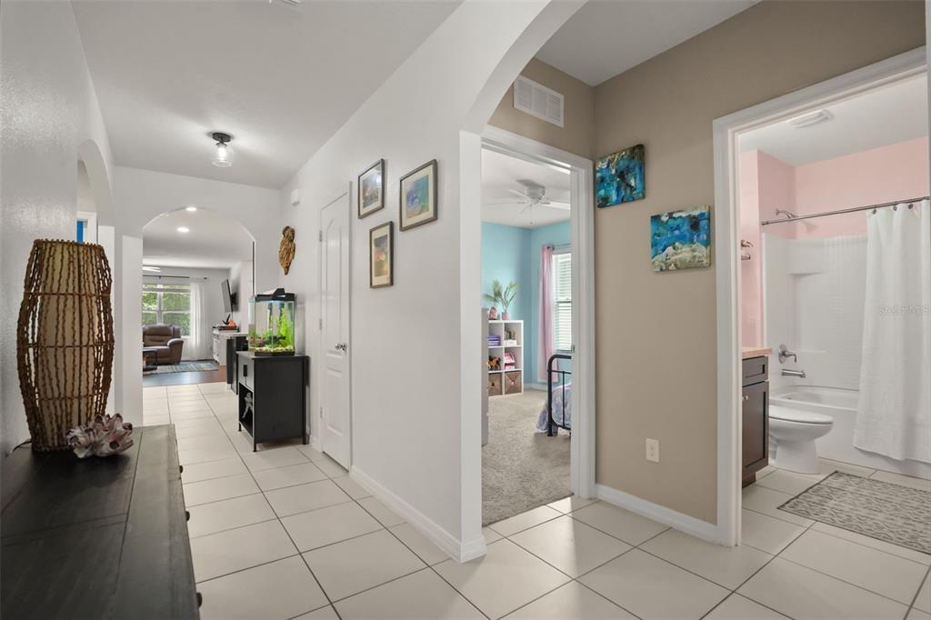 A tiled hallway leads to a living area, a bedroom, and a bathroom — 3422 BERKSHIRE WOODS TERRACE, DELTONA, FL