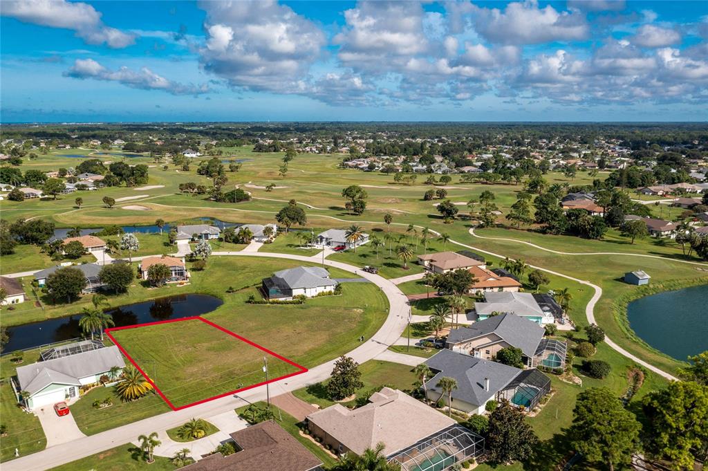 An aerial view shows a vacant residential lot outlined in red within a golf course community — 19 BUNKER TERRACE, ROTONDA WEST, FL