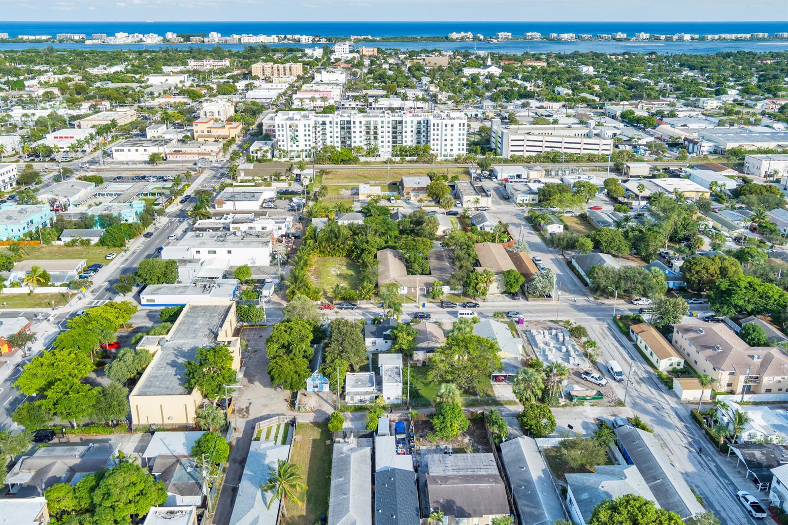 An aerial view shows a residential and commercial neighborhood near a coastal waterway — 19 S E Street, FL 33460, FL