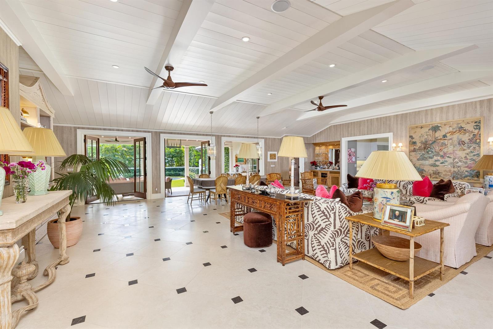 A spacious living room with vaulted ceilings, tiled floors, and open doors to a patio — 258 List Road, Palm Beach FL 33480, PALM BEACH, FL
