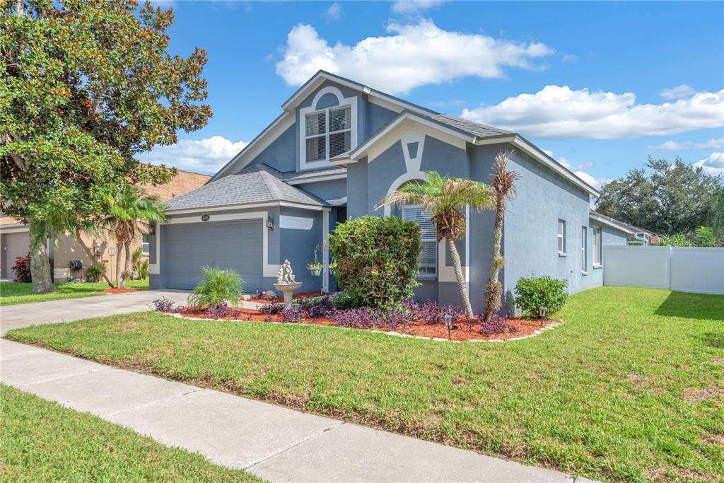A blue, single-story suburban house with a two-car garage and a front lawn — 4306 ORANGE RIDGE COURT, VALRICO, FL