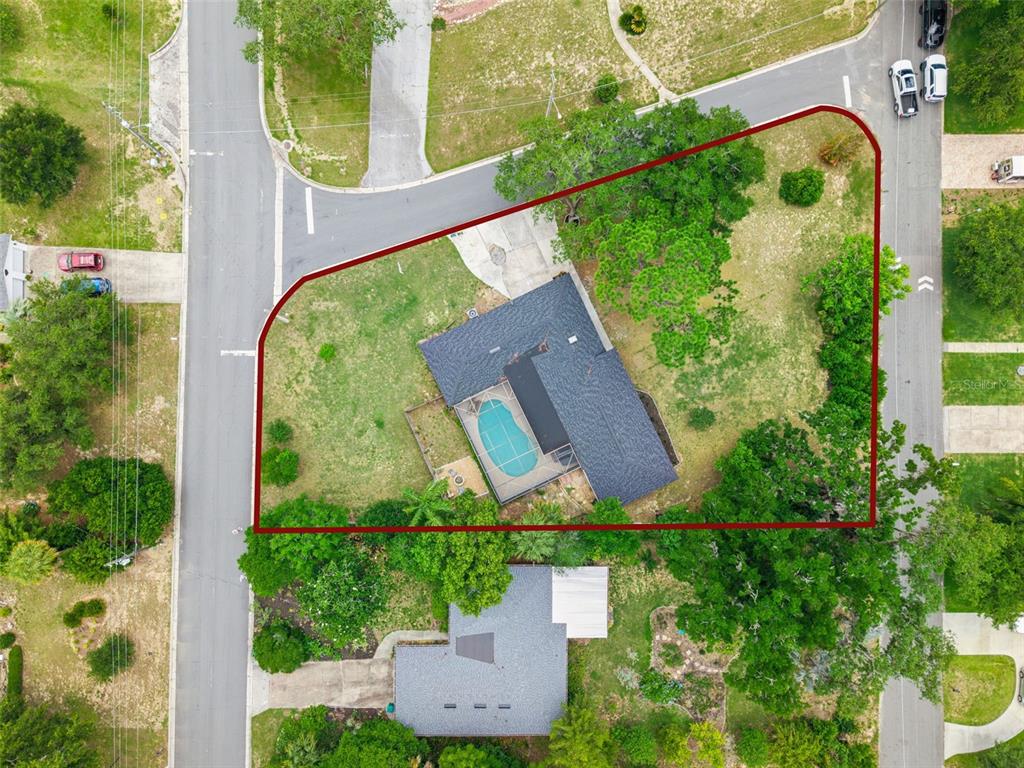 An aerial view shows a house with a pool on a corner lot — 1510 OVERLOOK DRIVE, MOUNT DORA, FL