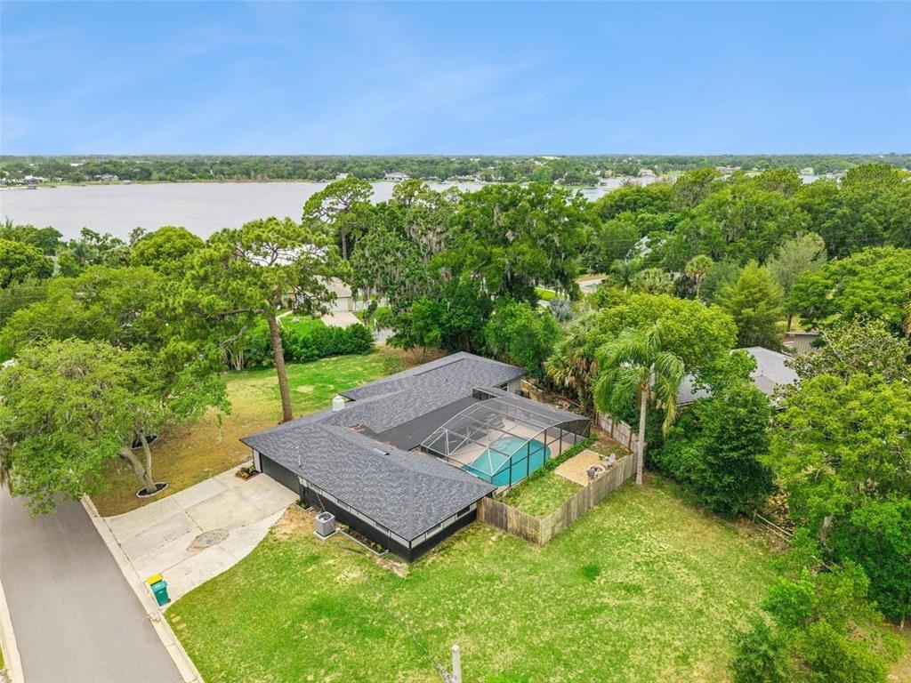 An aerial view shows a single-story house with a screened pool and a large yard — 1510 OVERLOOK DRIVE, MOUNT DORA, FL