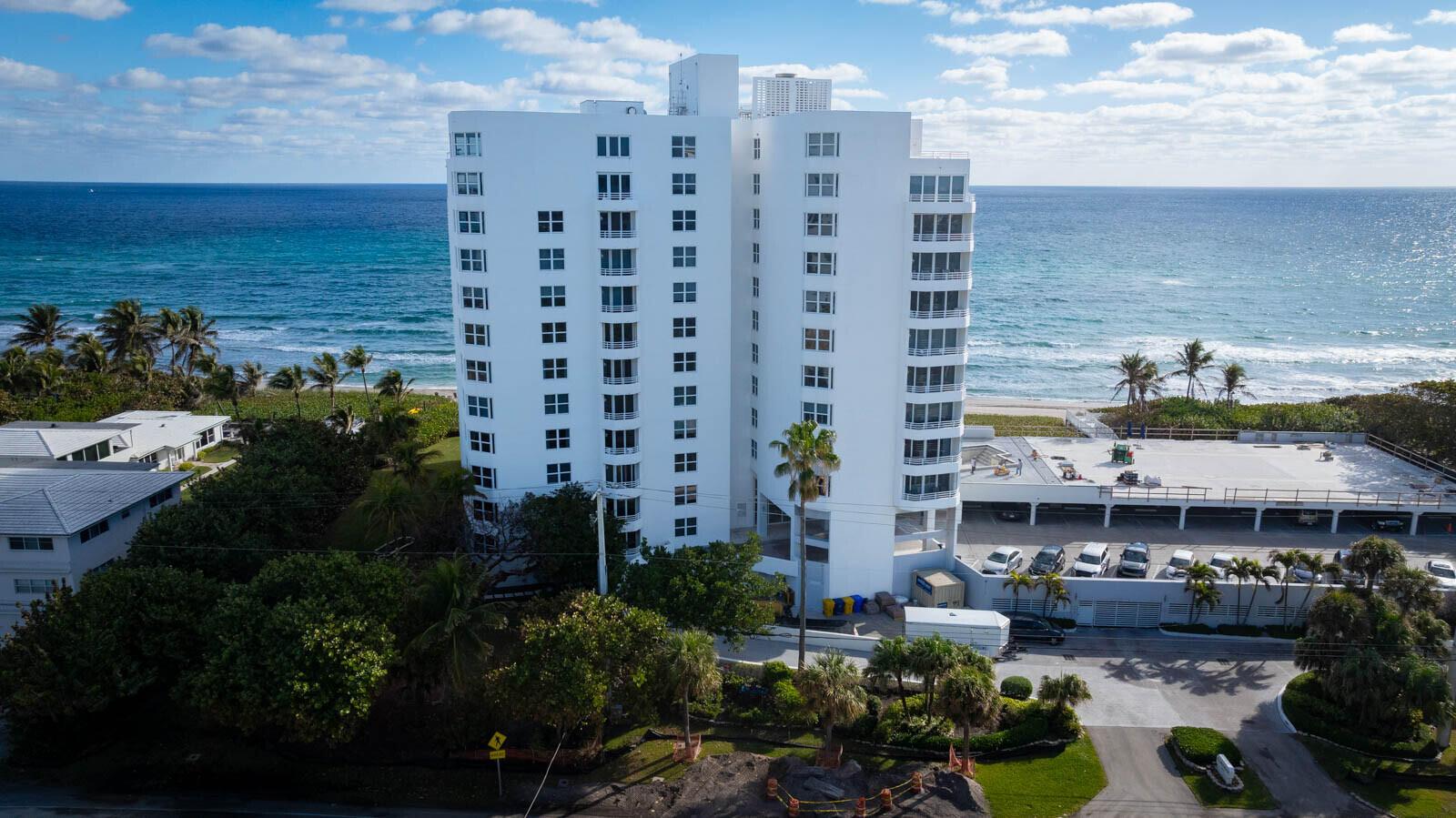 An aerial view of a white high-rise condominium building situated along a sandy beach — 3407 S Ocean Boulevard # 8a, Highland Beach FL 33487, HIGHLAND BEACH, FL
