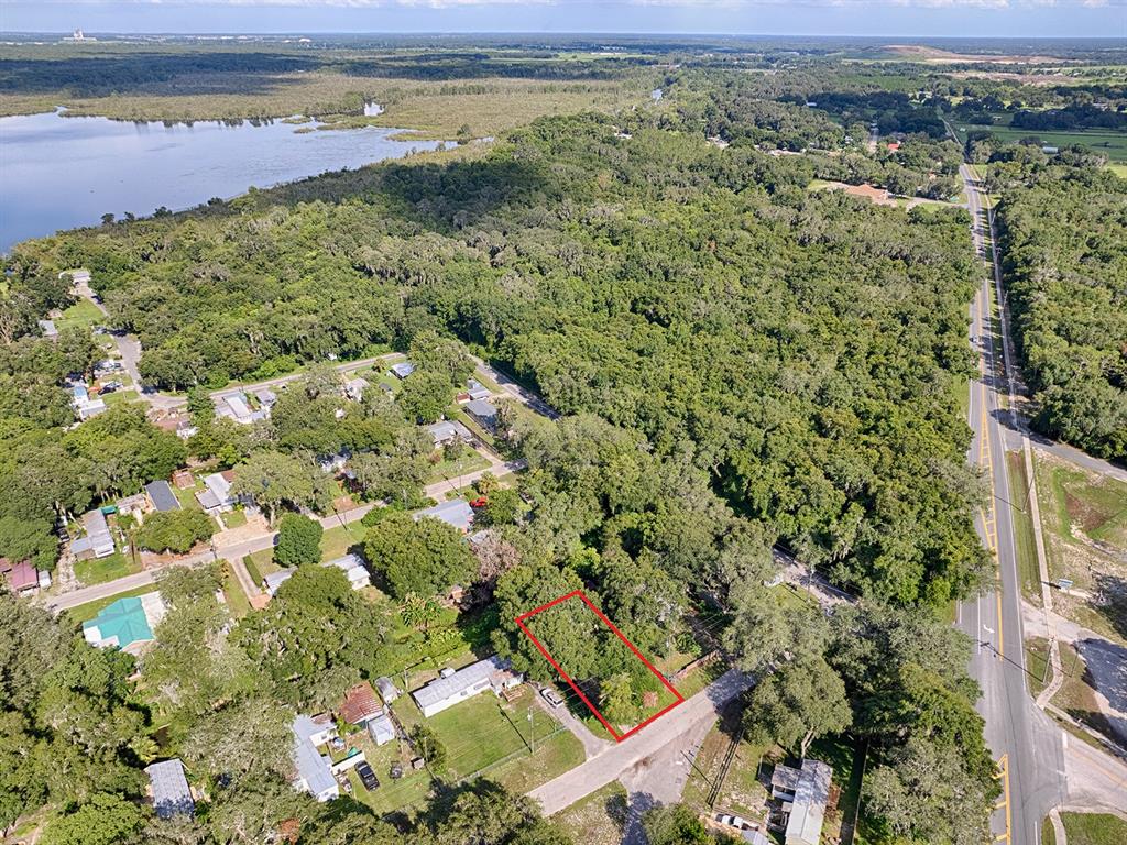 An aerial view shows a rectangular vacant lot outlined in red near a paved road — 853 CR 484, LAKE PANASOFFKEE, FL