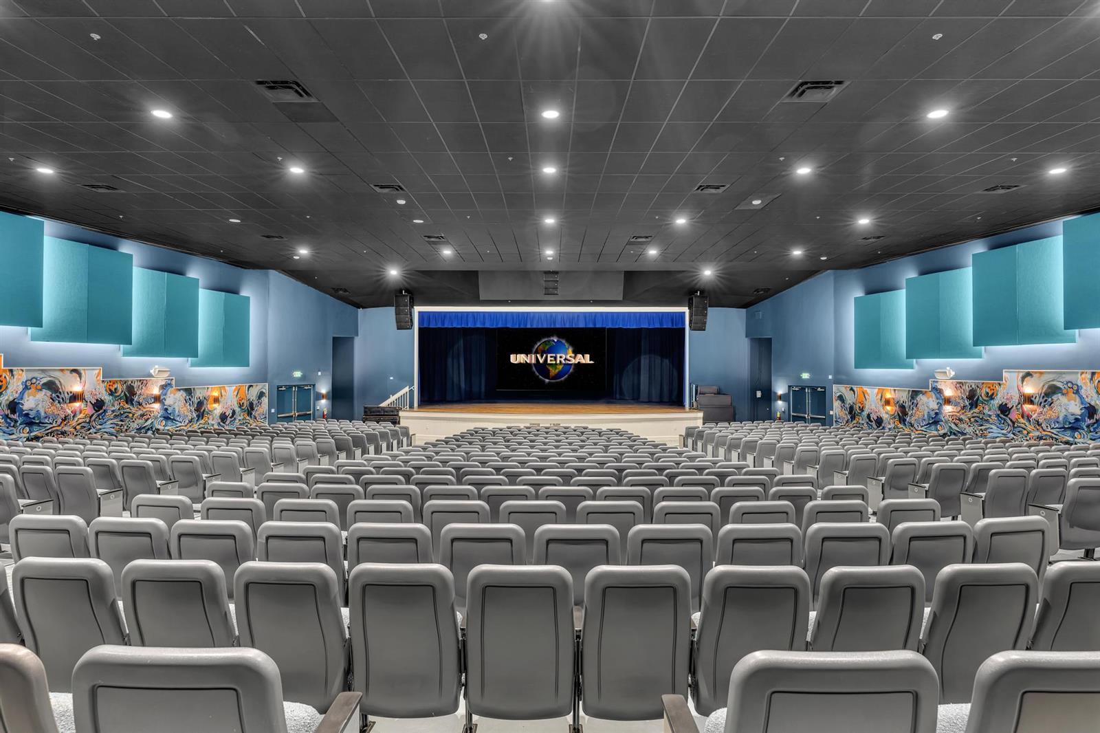 A large auditorium features rows of gray seats facing a stage with a screen — 9589 Shadybrook Drive # 201, Boynton Beach FL 33437, BOYNTON BEACH, FL