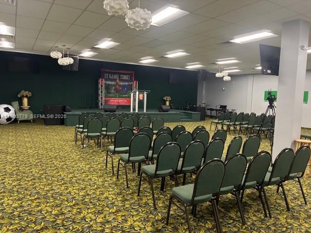 A large room with rows of chairs facing a stage featuring a banner — 4257 NW 12 ST, Lauderhill FL 33313, LAUDERHILL, FL