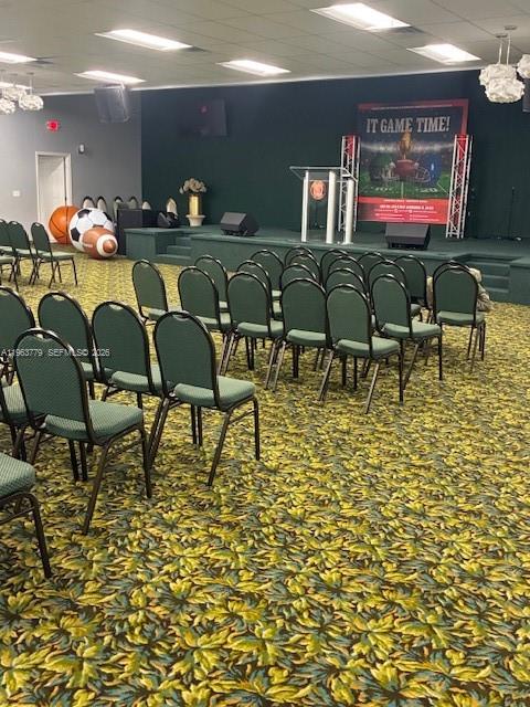 This room features rows of chairs facing a stage with a podium and banner — 4257 NW 12 ST, Lauderhill FL 33313, LAUDERHILL, FL